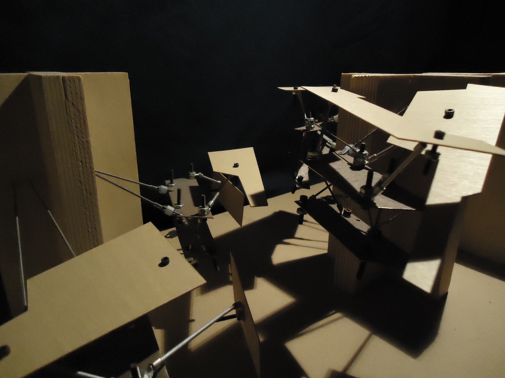 Detail of a physical architectural model with layered planes and metal connections.